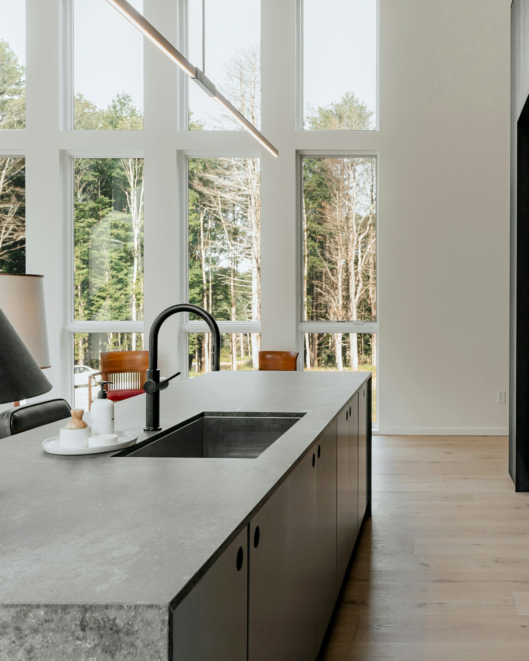 A dark modern kitchen in morning light